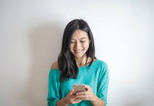 Woman Smiling at Smartphone